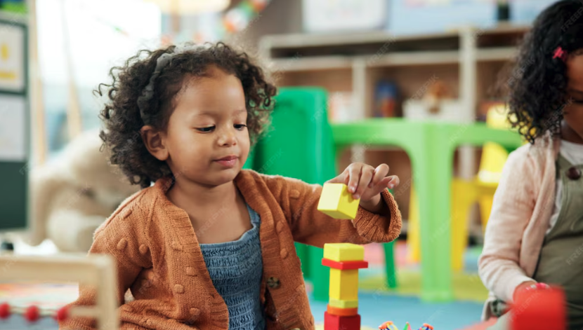 Preschooler playing with colorful building blocks